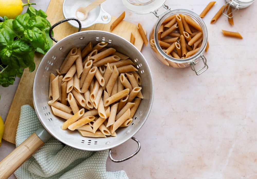 a pan filled with pasta sitting on top of a counter
