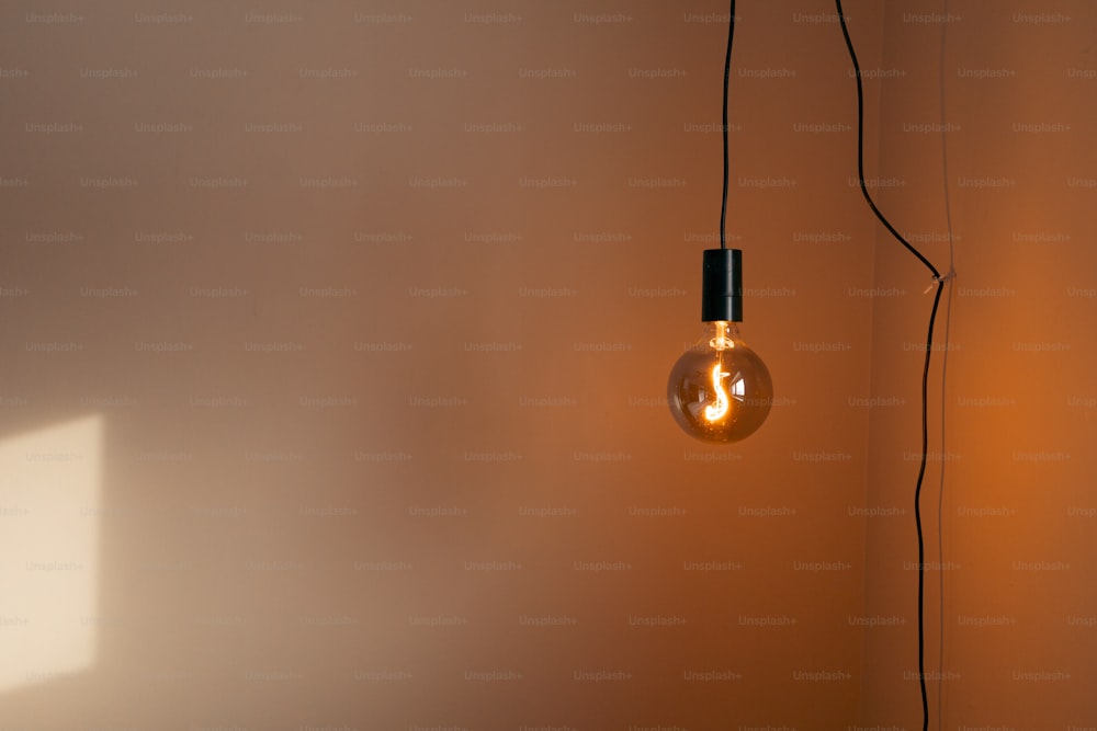 a light bulb hanging from a wall in a room