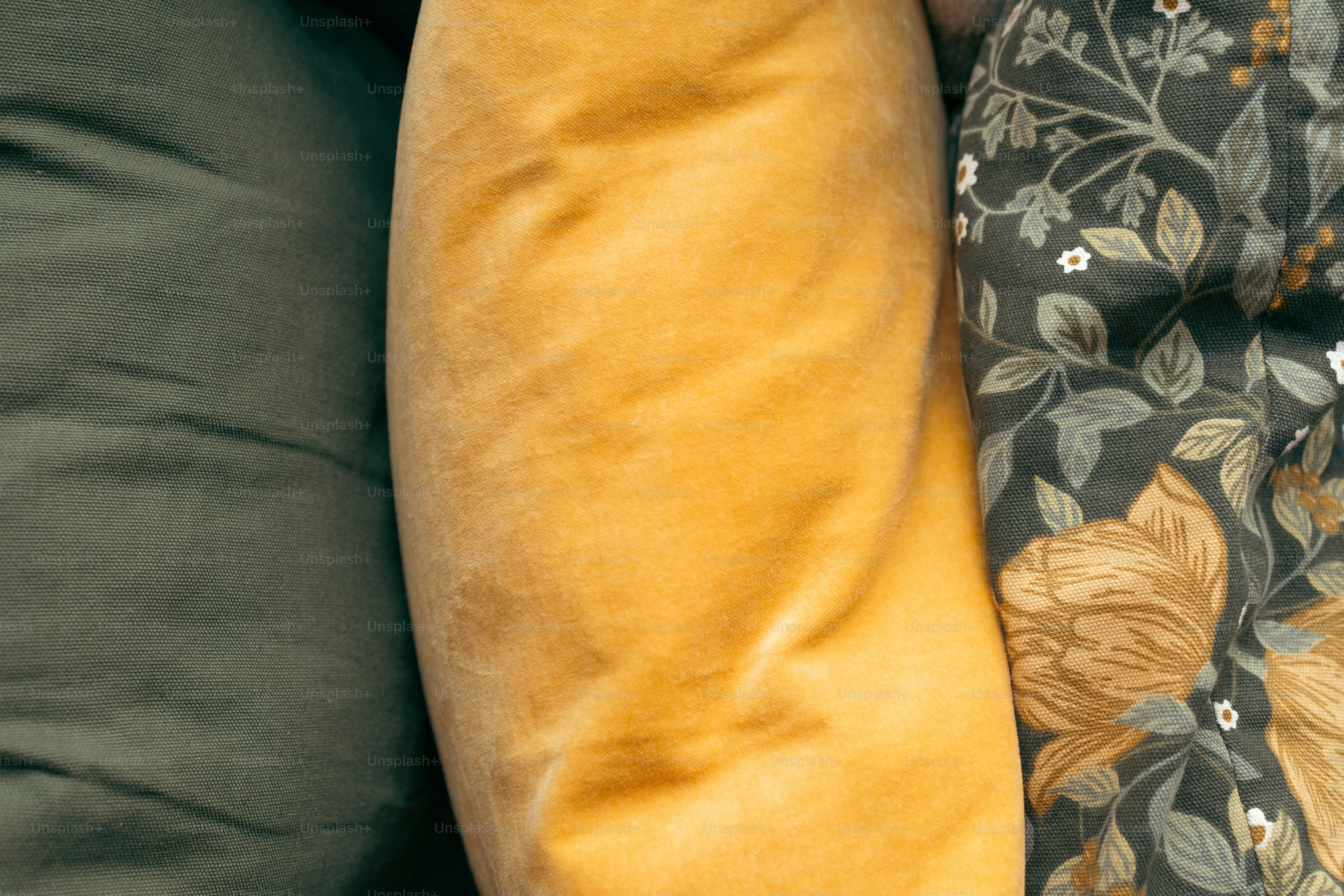 a close up of two pillows on a couch