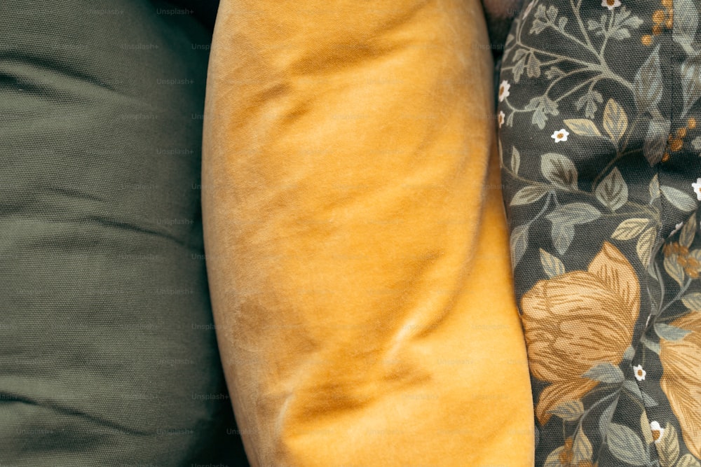 a close up of two pillows on a couch