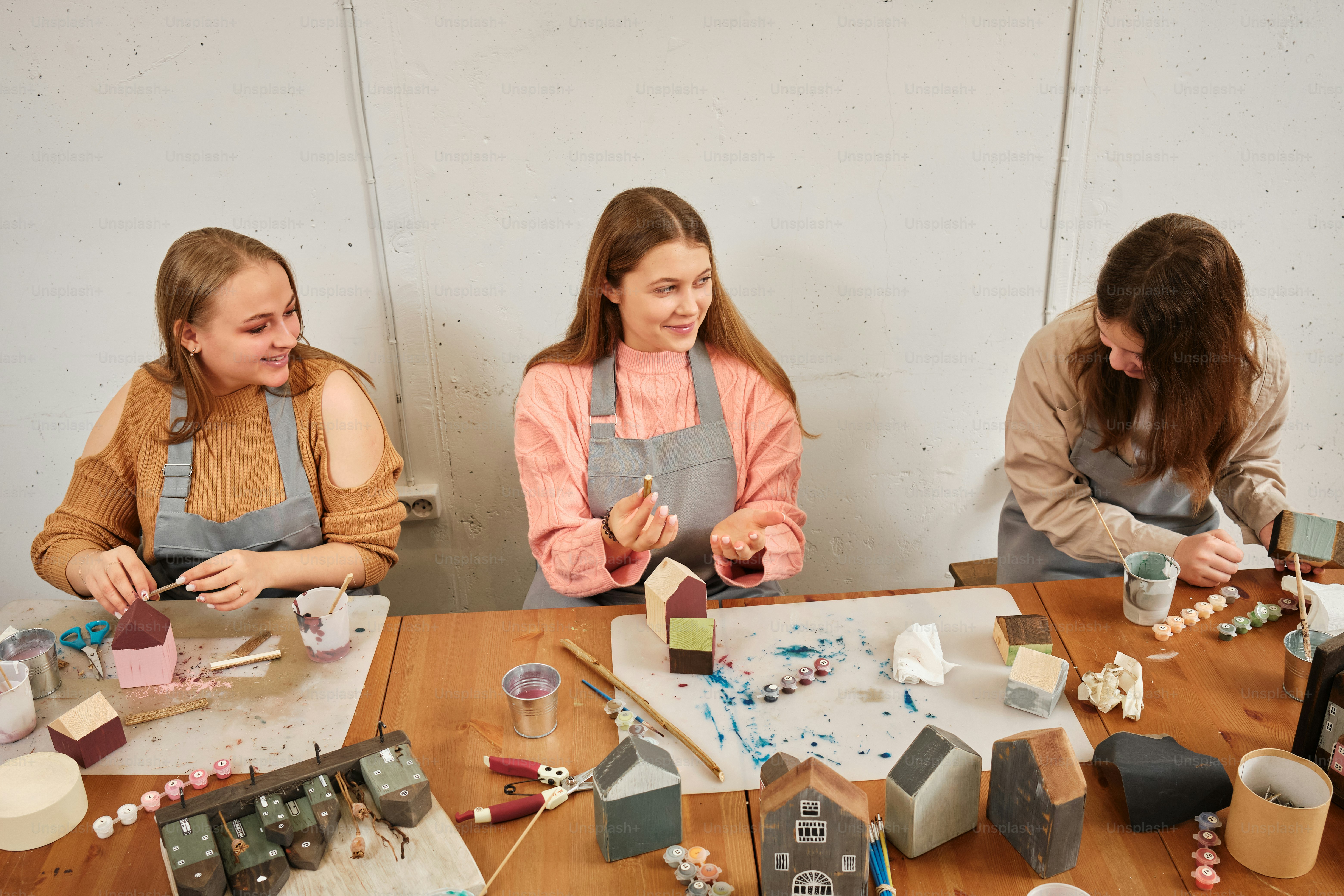 a group of women sitting around a wooden table