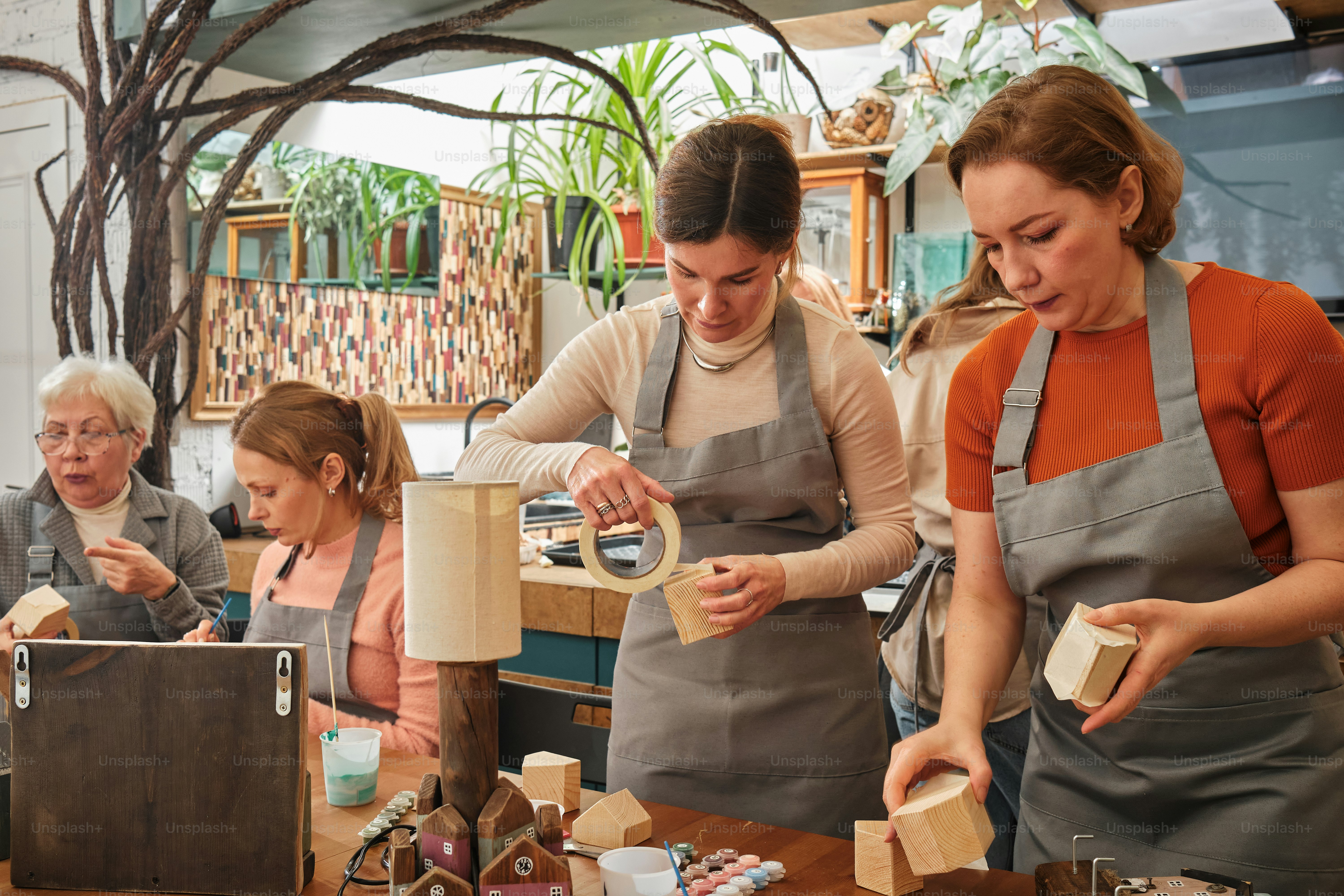 a group of women standing around a wooden table