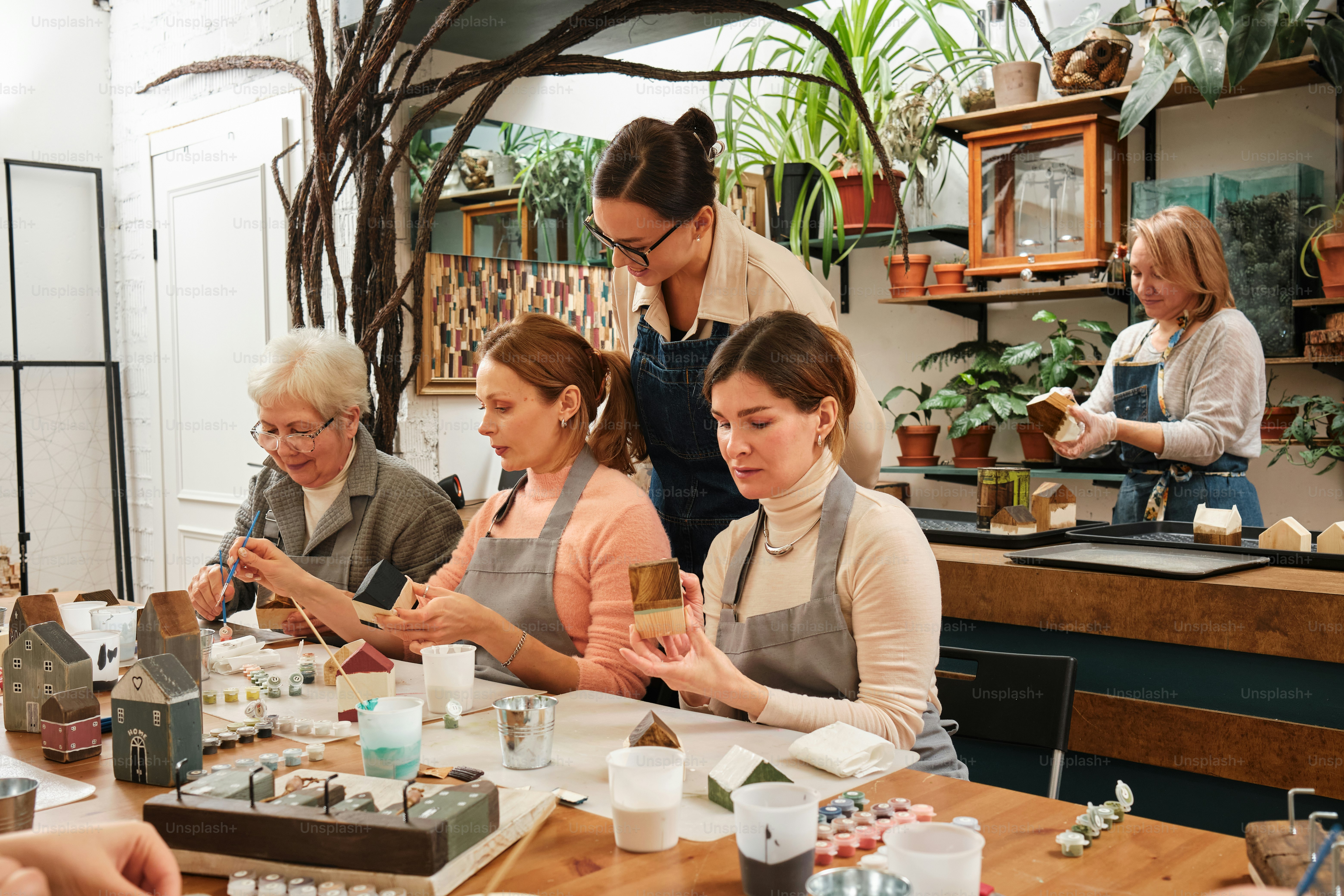 eine Gruppe von Frauen, die um einen Holztisch sitzen