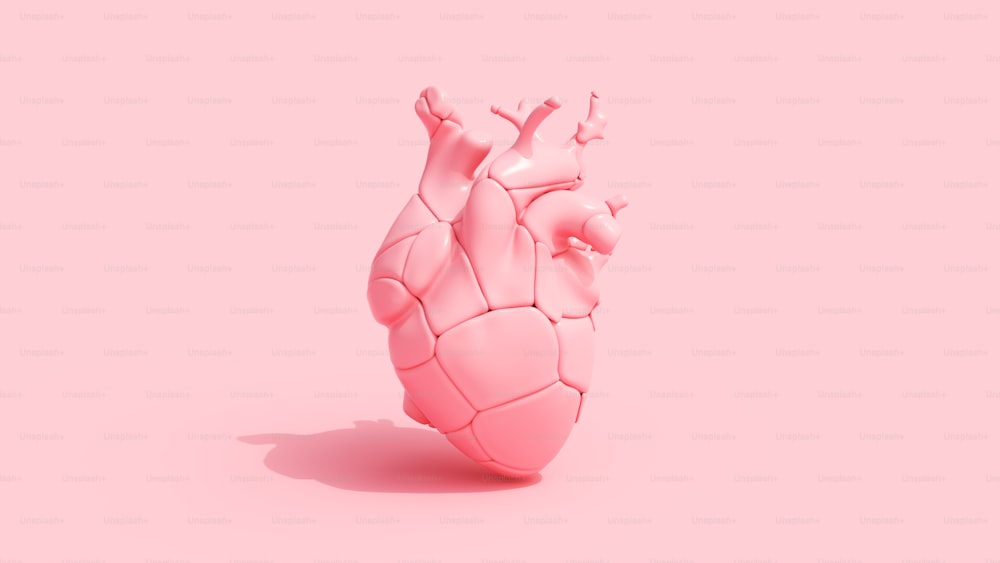 un oggetto a forma di cuore su sfondo rosa