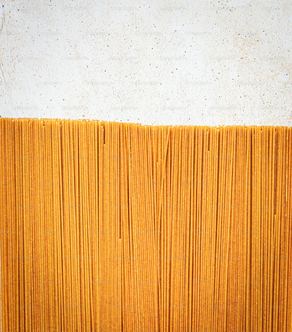 a close up of a yellow wall with a white wall in the background