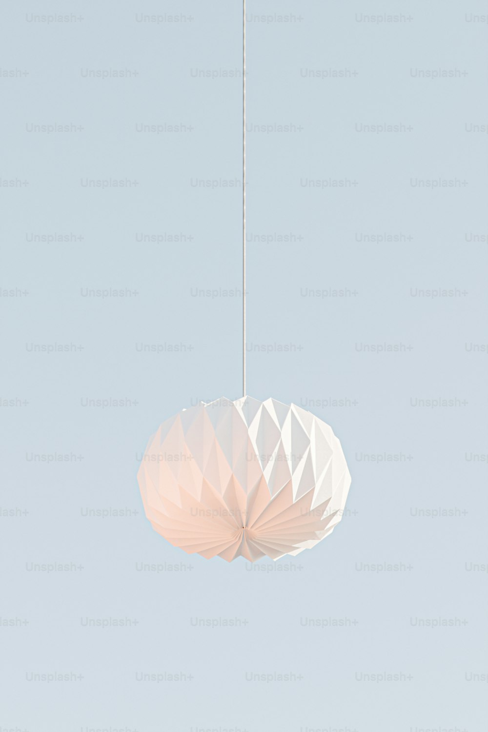 a white light fixture hanging from a ceiling