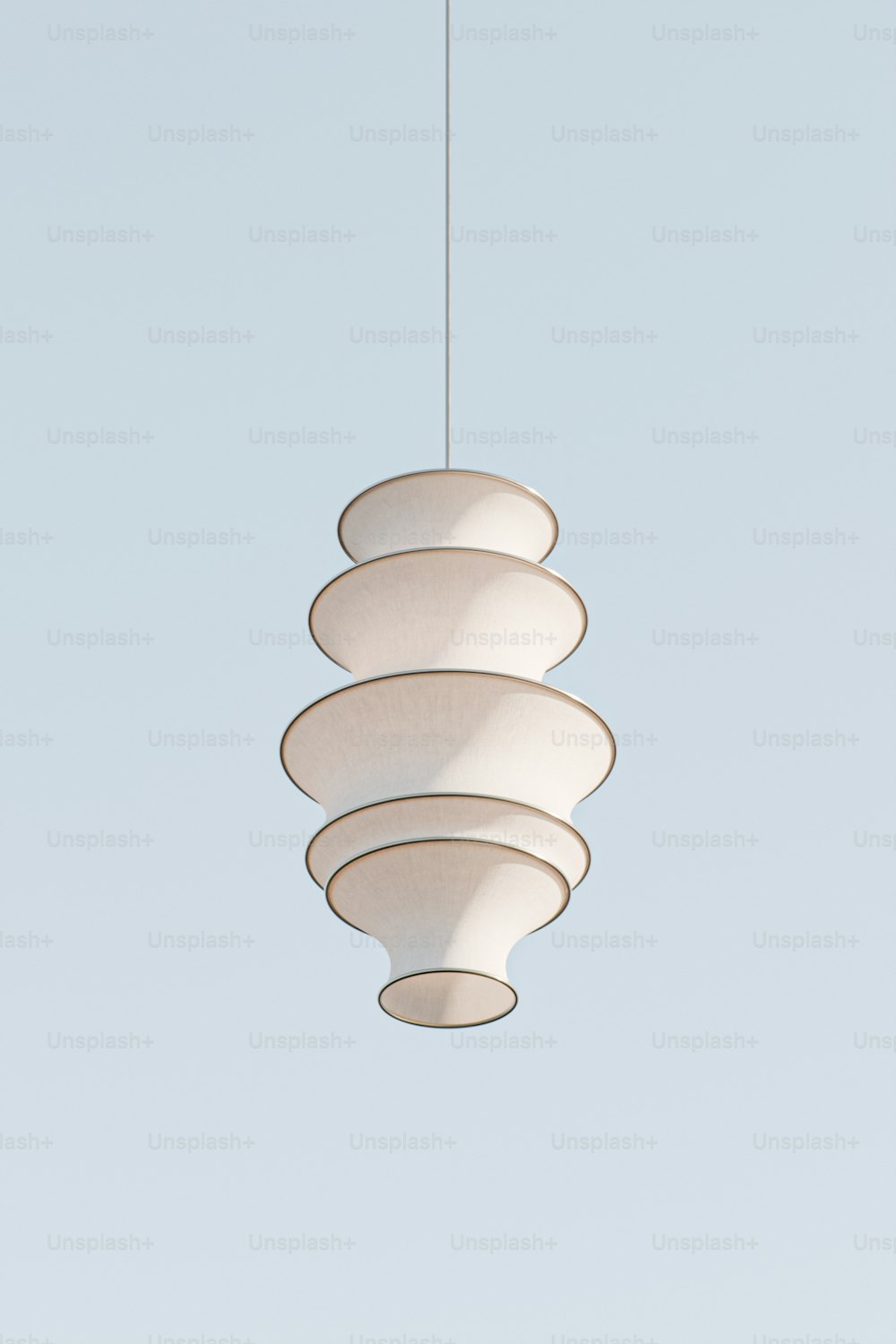 a white light fixture hanging from a ceiling