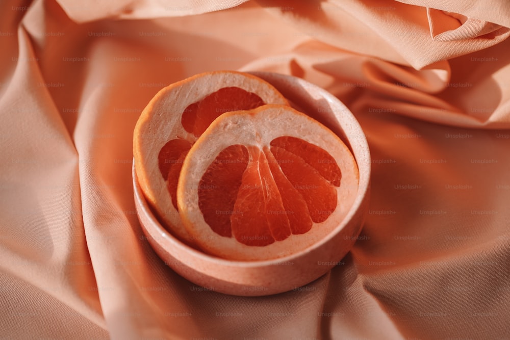 a couple of slices of orange sitting in a bowl