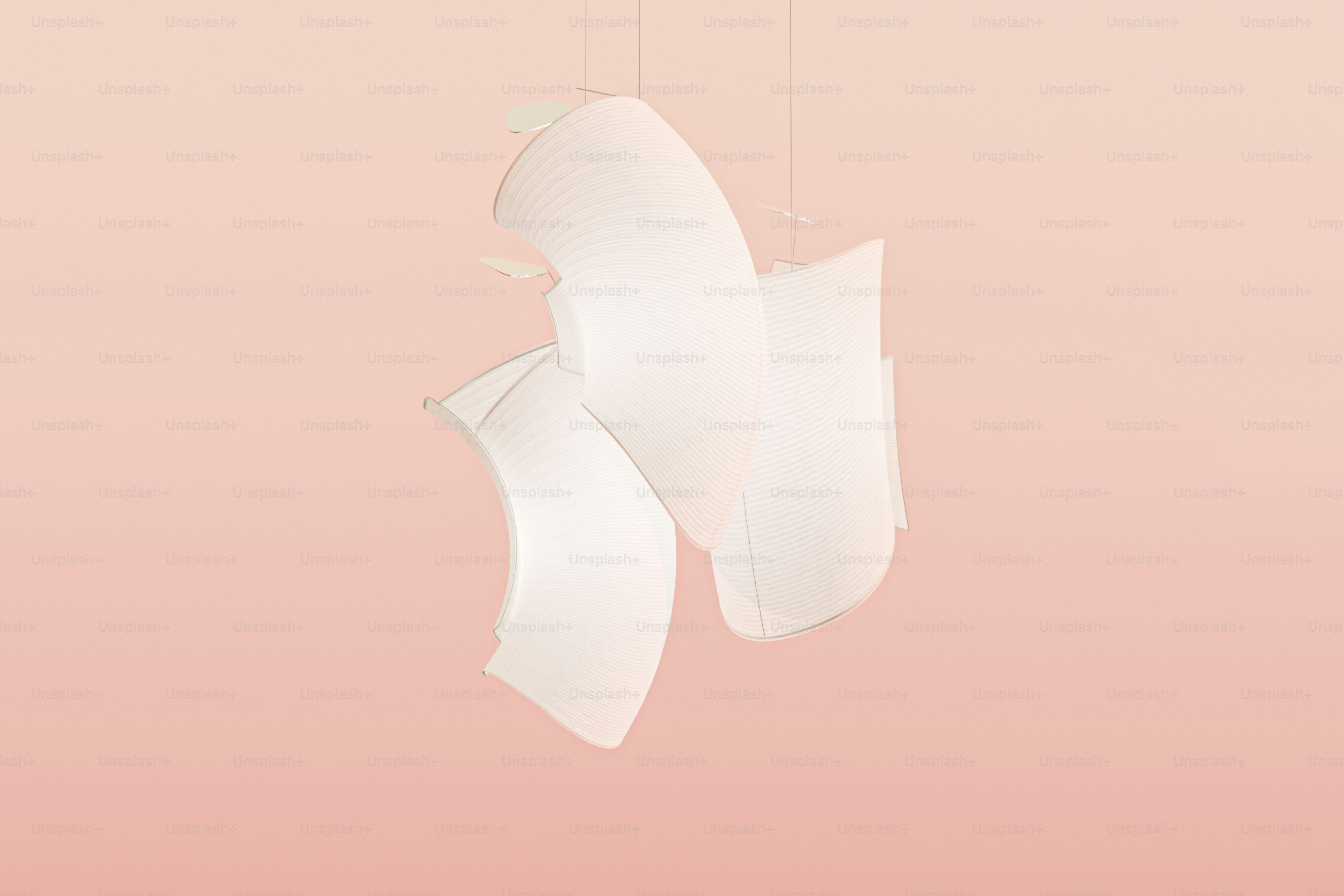 a couple of white lights hanging from a pink ceiling