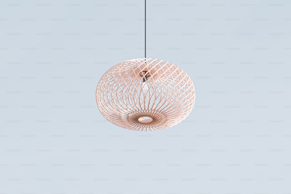 a white light fixture hanging from a wire