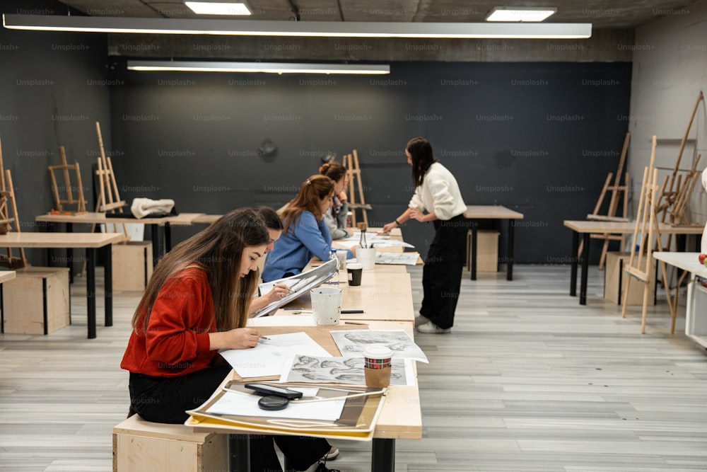 a group of people sitting at desks in a room