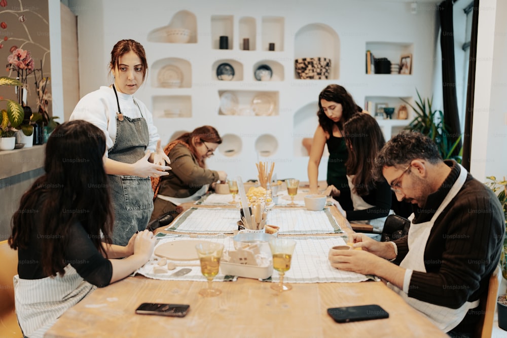 a group of people sitting around a wooden table