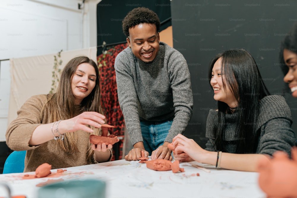 a group of people standing around a table