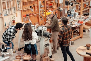 a group of people working in a wood shop