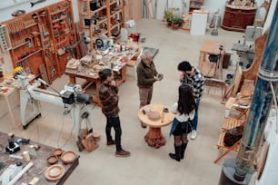 a group of people standing around a table in a room