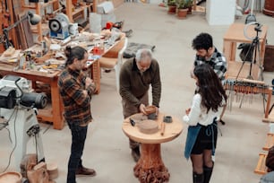 a group of people standing around a wooden table
