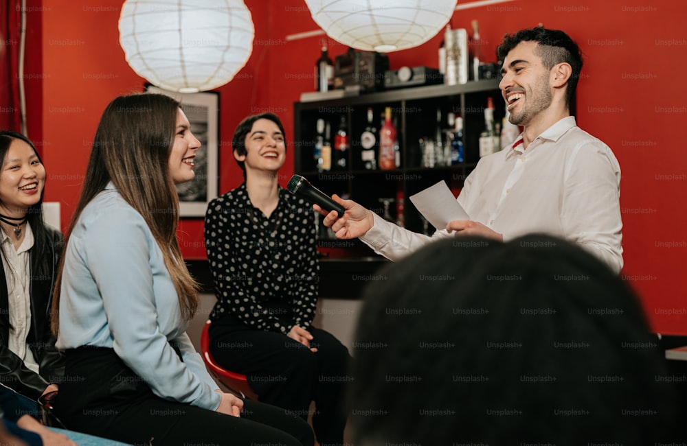 a group of people sitting around each other in a room