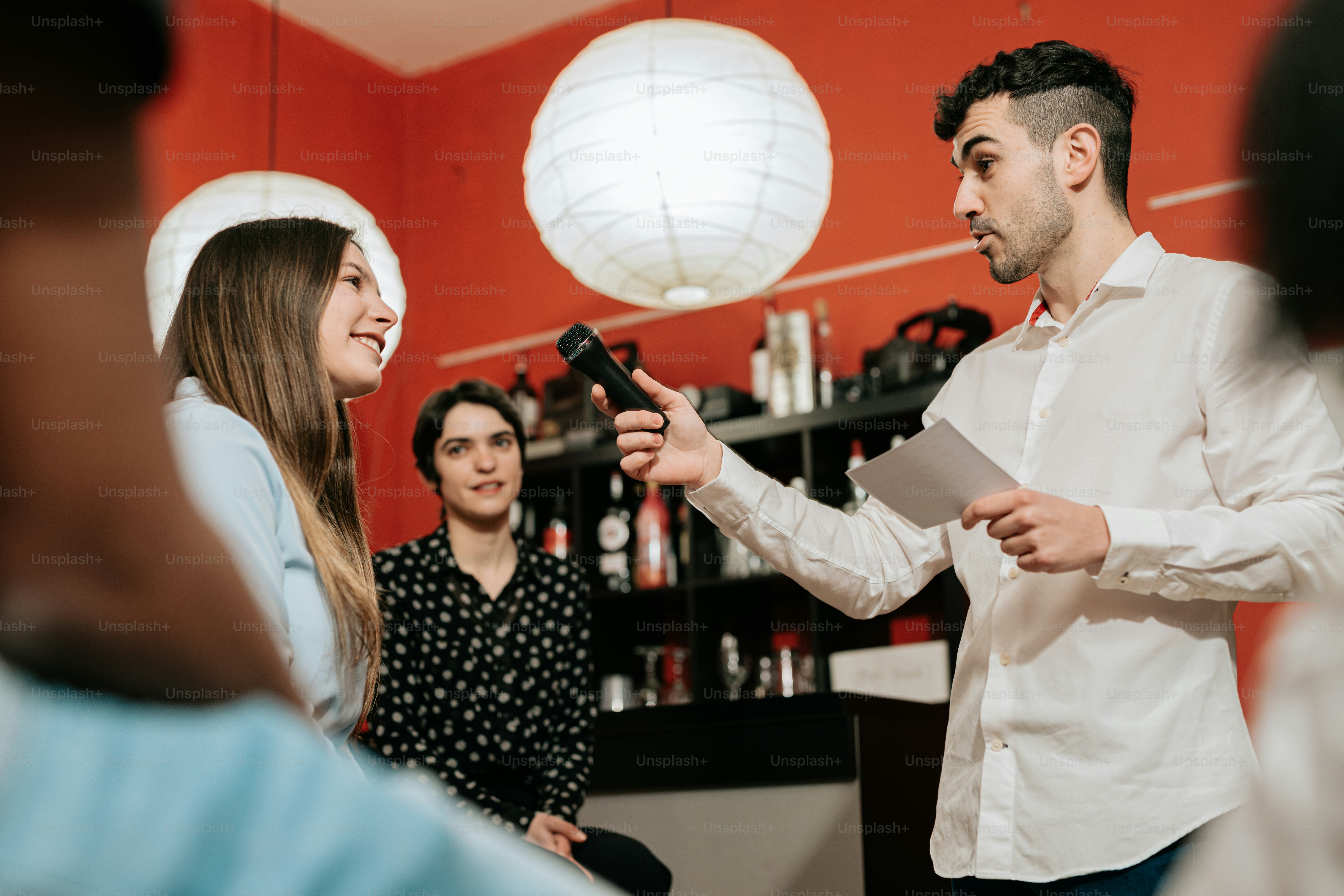 a man standing next to a woman holding a microphone