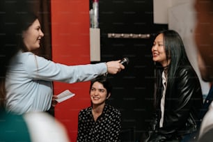 a group of women standing around each other