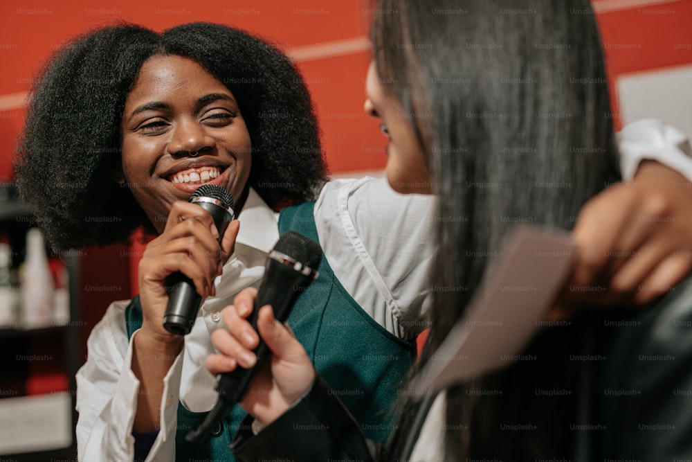 a woman holding a microphone in her right hand