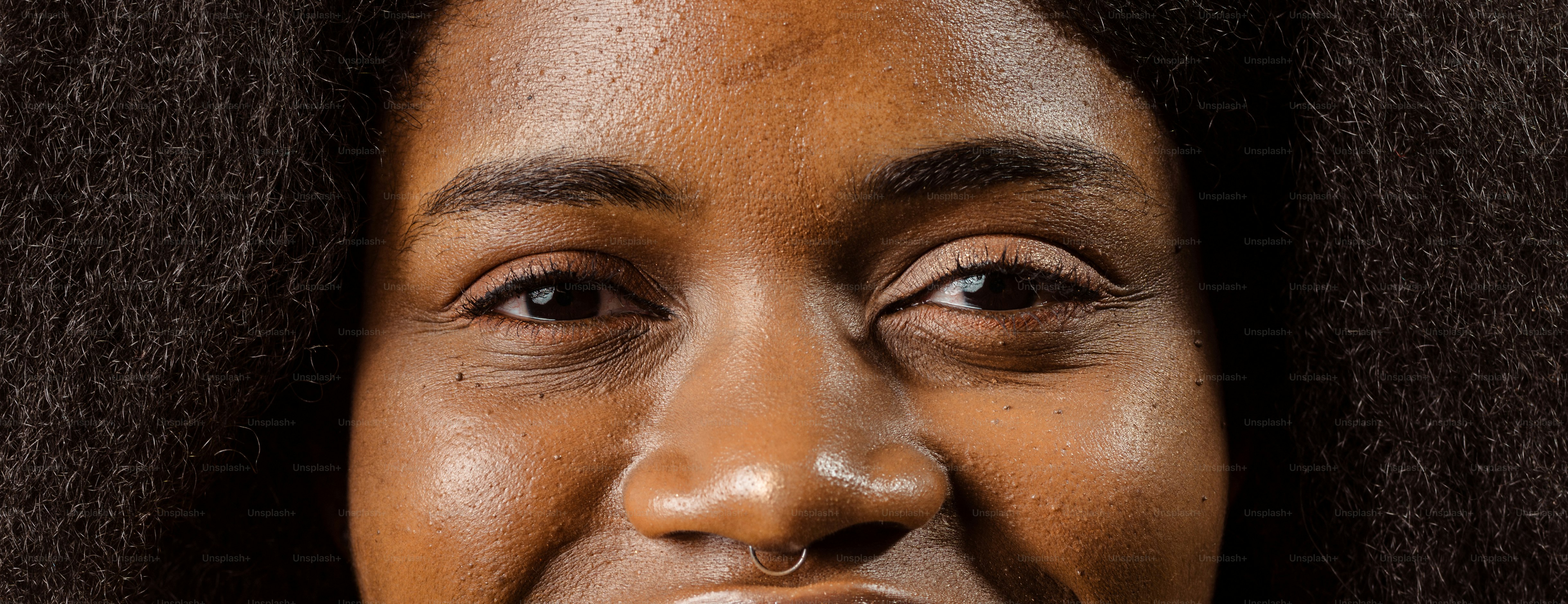 un primo piano del viso di una donna con i capelli castani