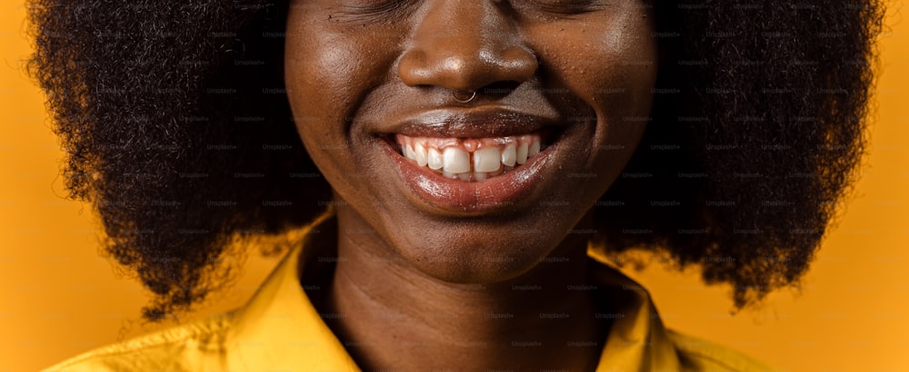 a close up of a person wearing a yellow shirt