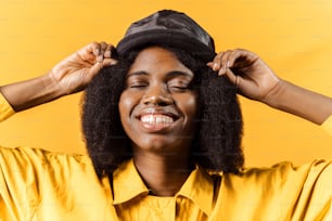 a woman wearing a yellow shirt and a hat