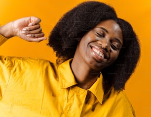 a woman in a yellow shirt is smiling