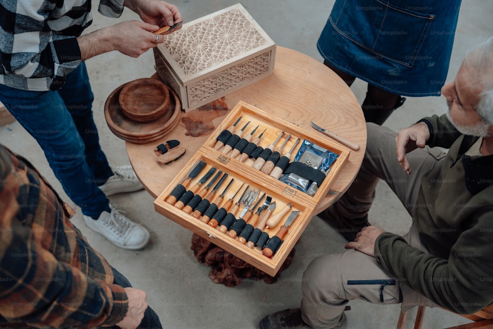 a group of people standing around a wooden table