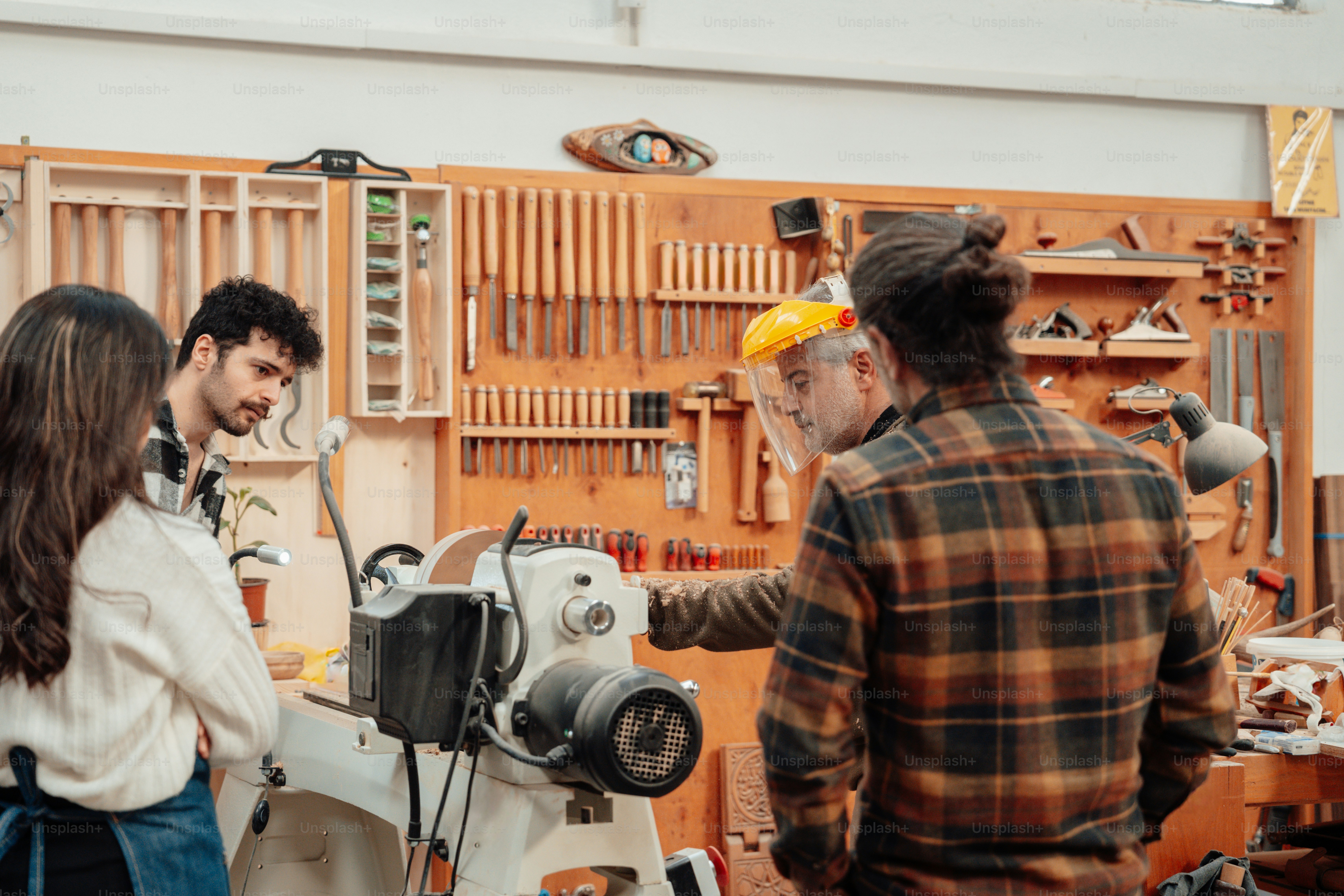 a group of people standing around a machine