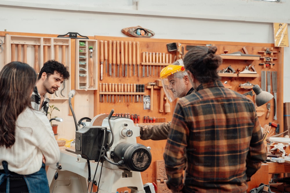 a group of people standing around a machine