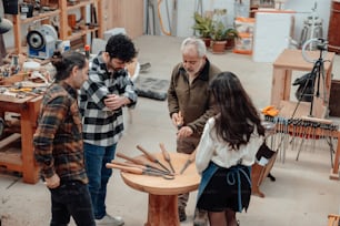 a group of people standing around a wooden table