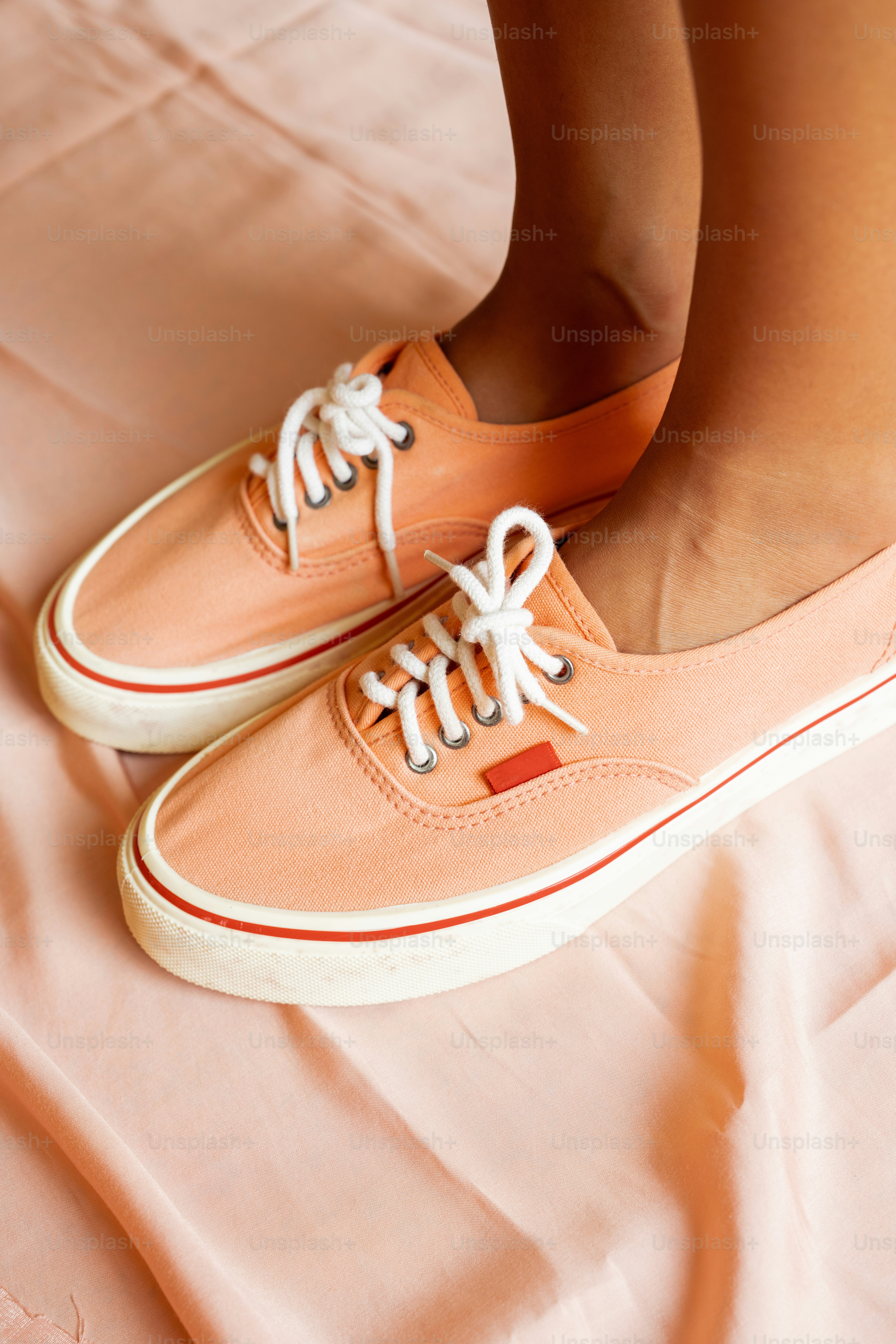 a close up of a person's shoes on a bed
