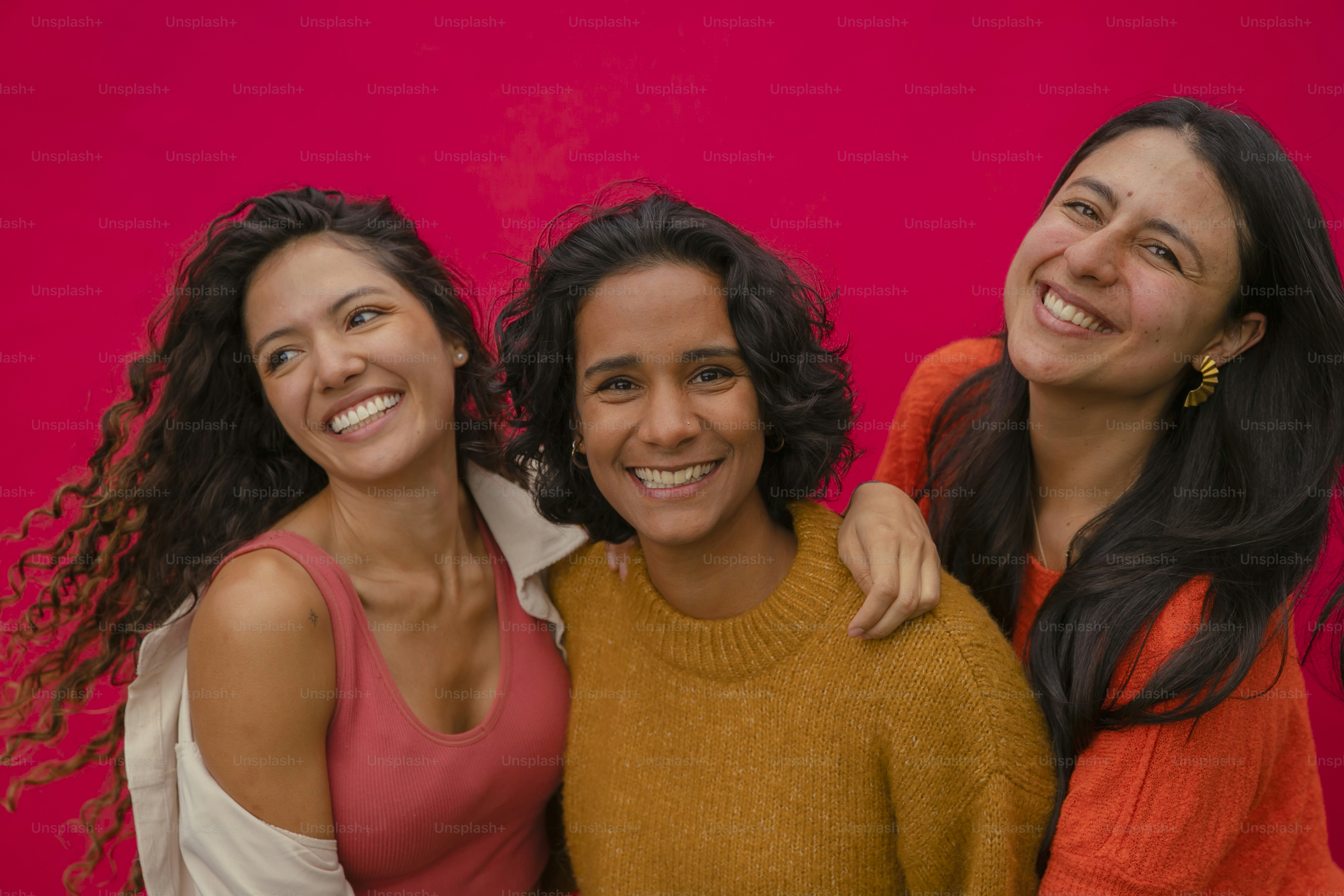 a group of three women standing next to each other