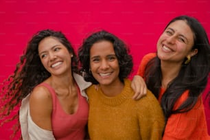 a group of three women standing next to each other