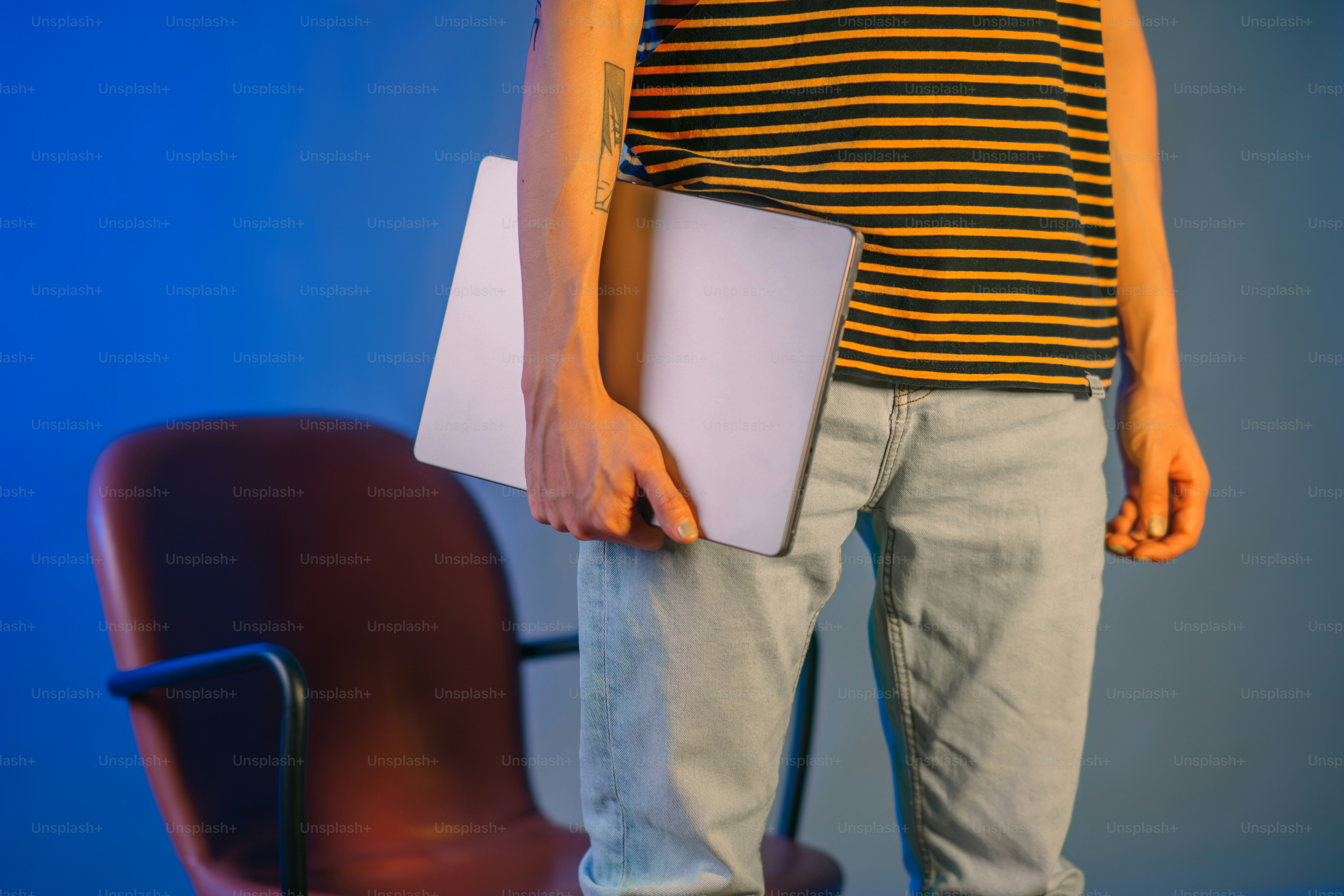 a person holding a laptop in their hand