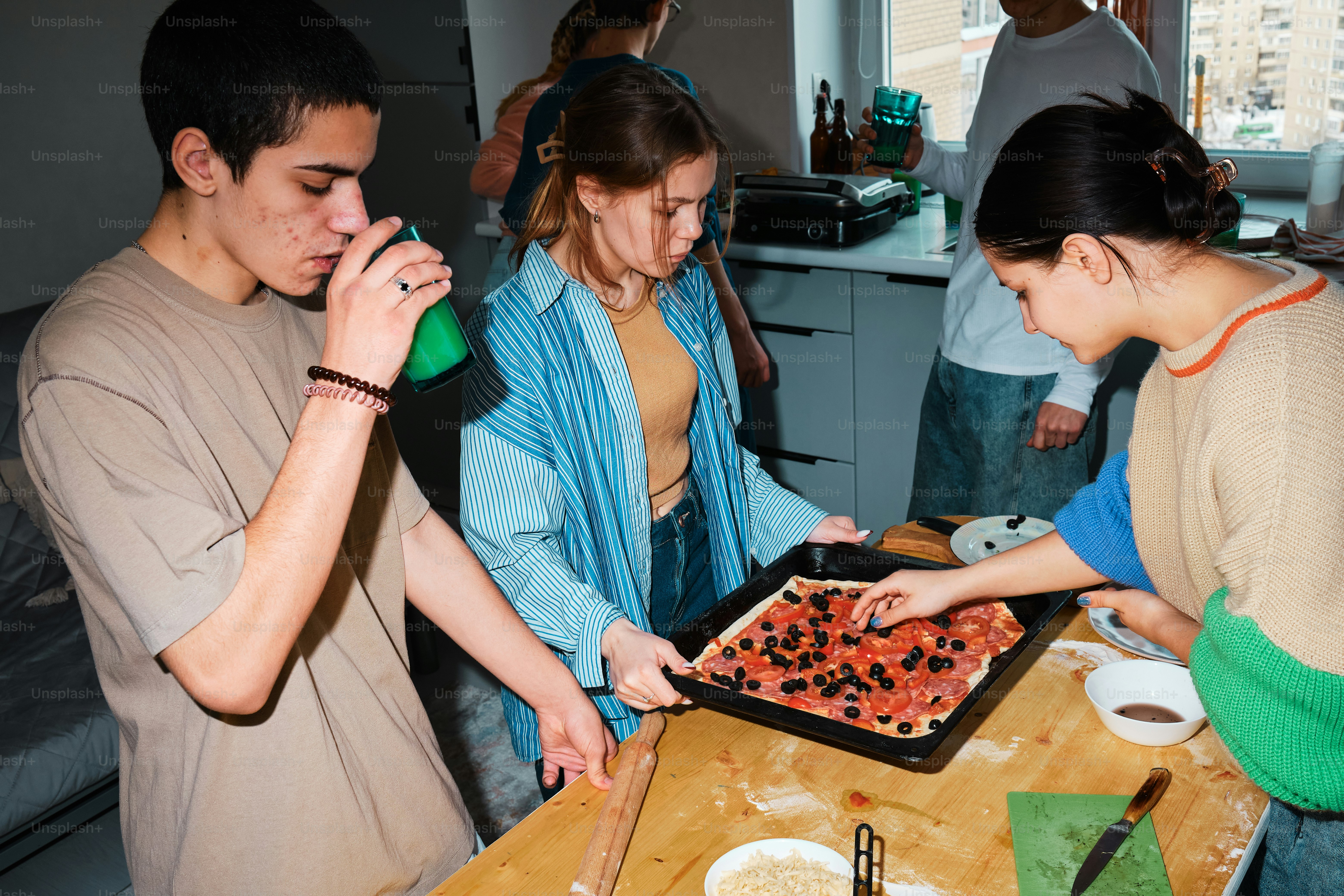 eine Gruppe von Menschen, die um einen Holztisch herum stehen