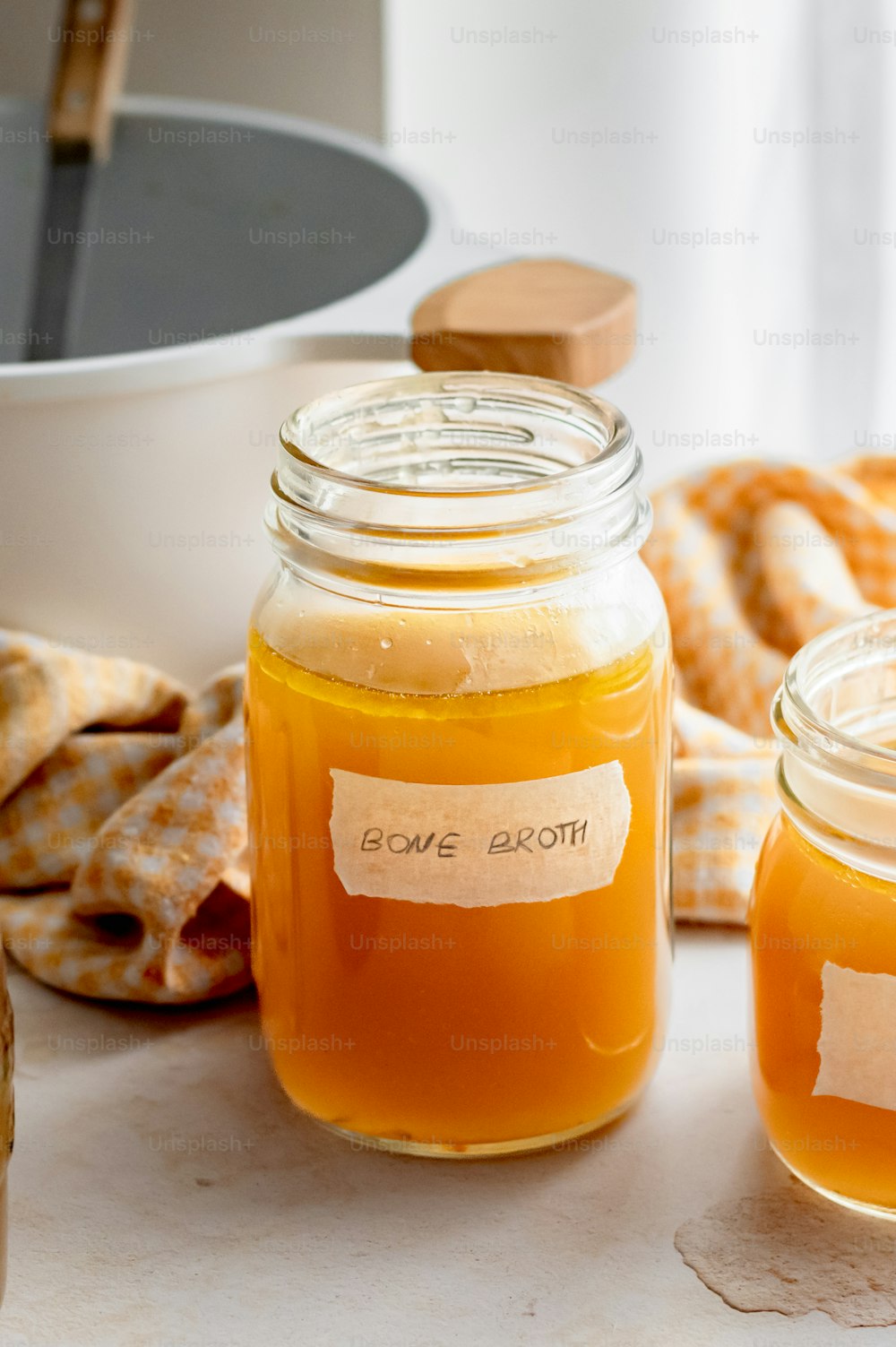 two jars of honey sit on a table