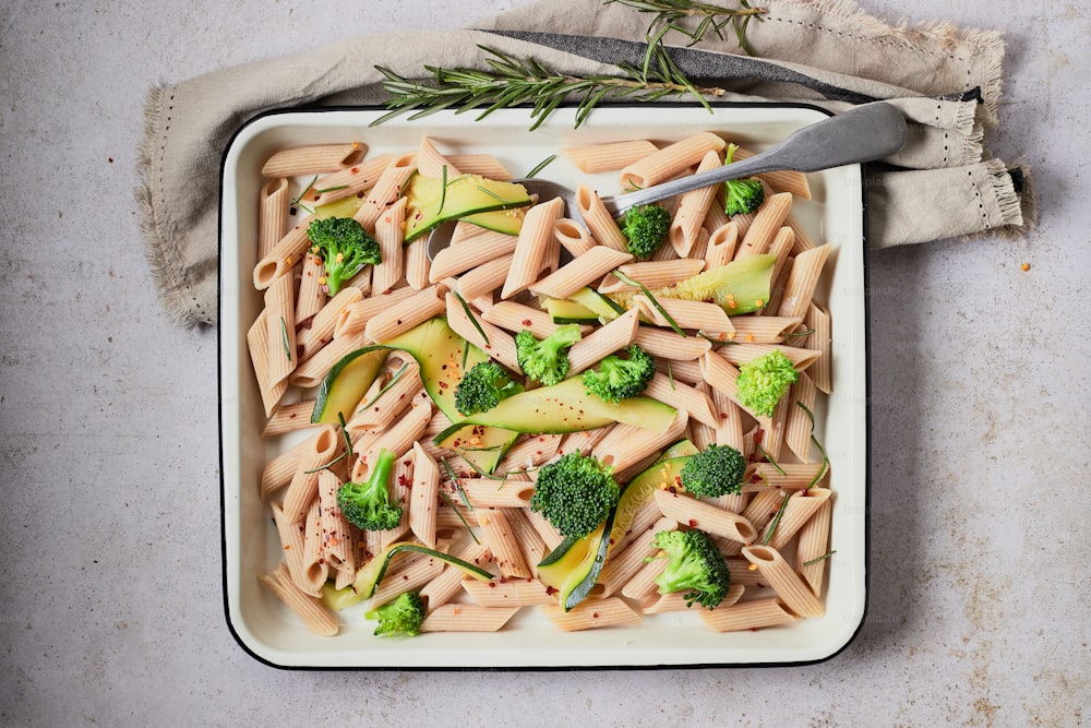 a dish of pasta with broccoli and cheese