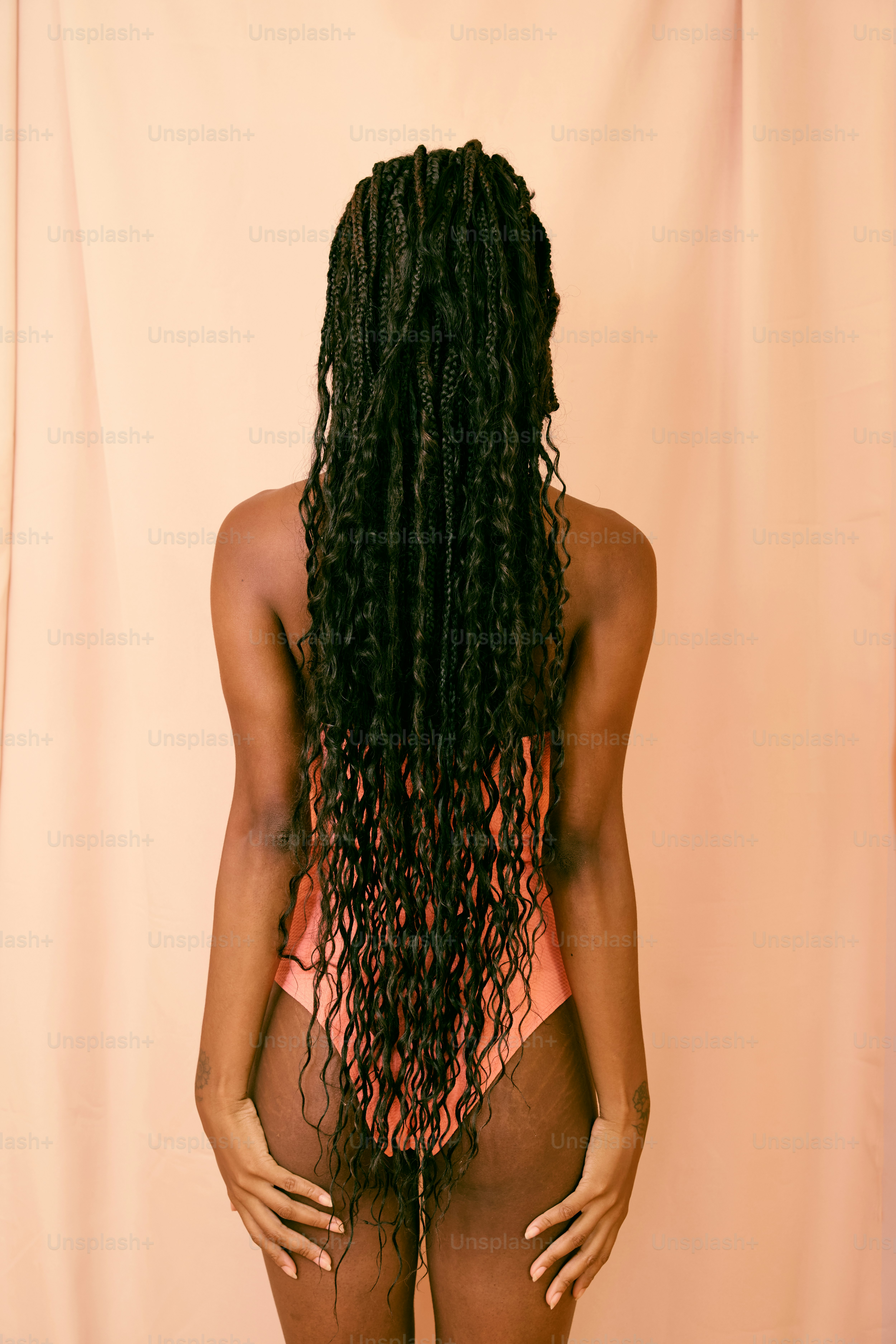 a woman with long curly hair in a bikini