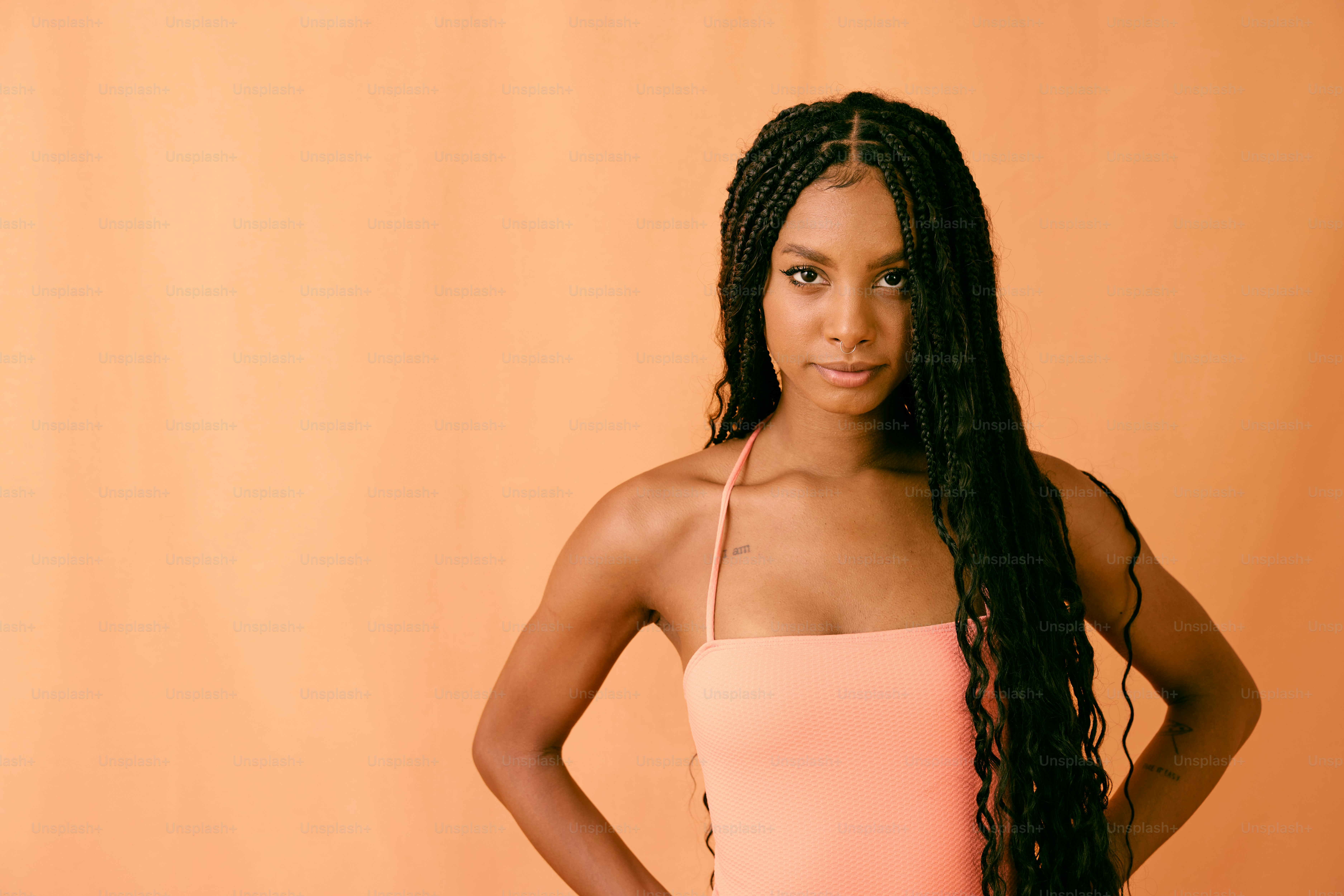a woman in a pink one piece swimsuit posing for a picture