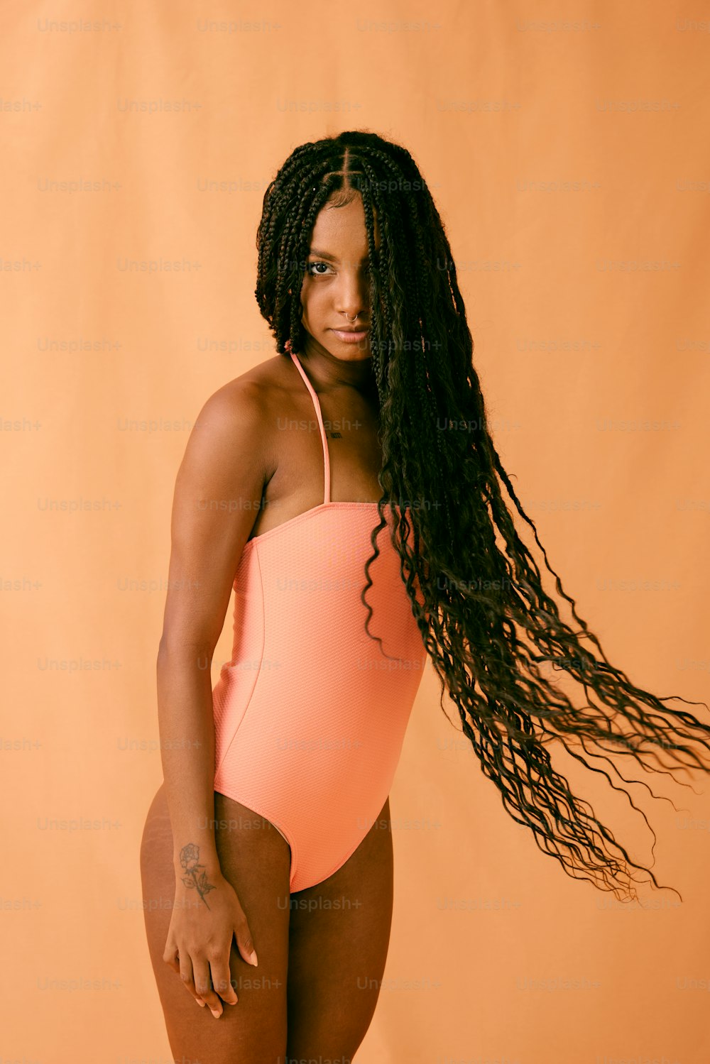 a woman in a pink swimsuit posing for a picture