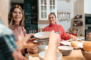 a group of people standing around a kitchen counter