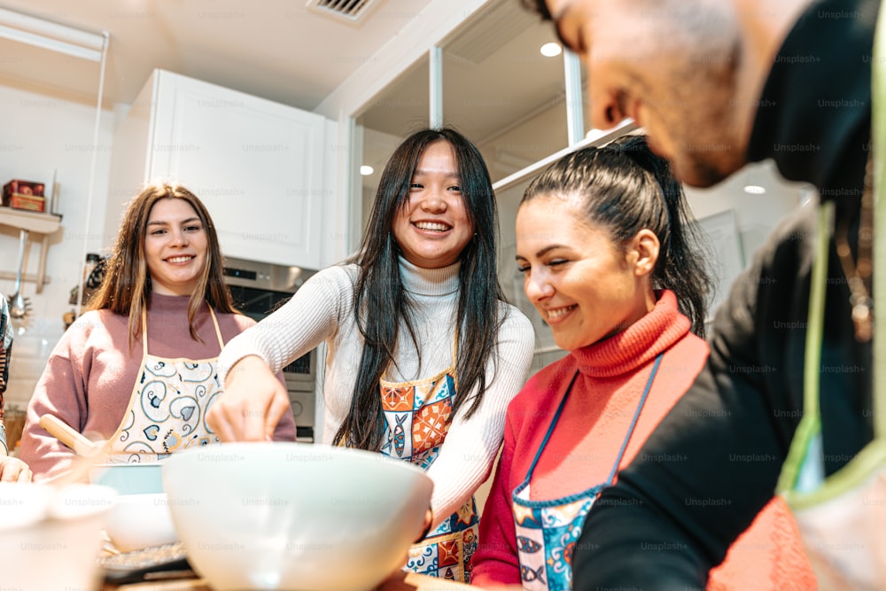 a group of people in a kitchen preparing food