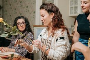 a group of women standing around a wooden table