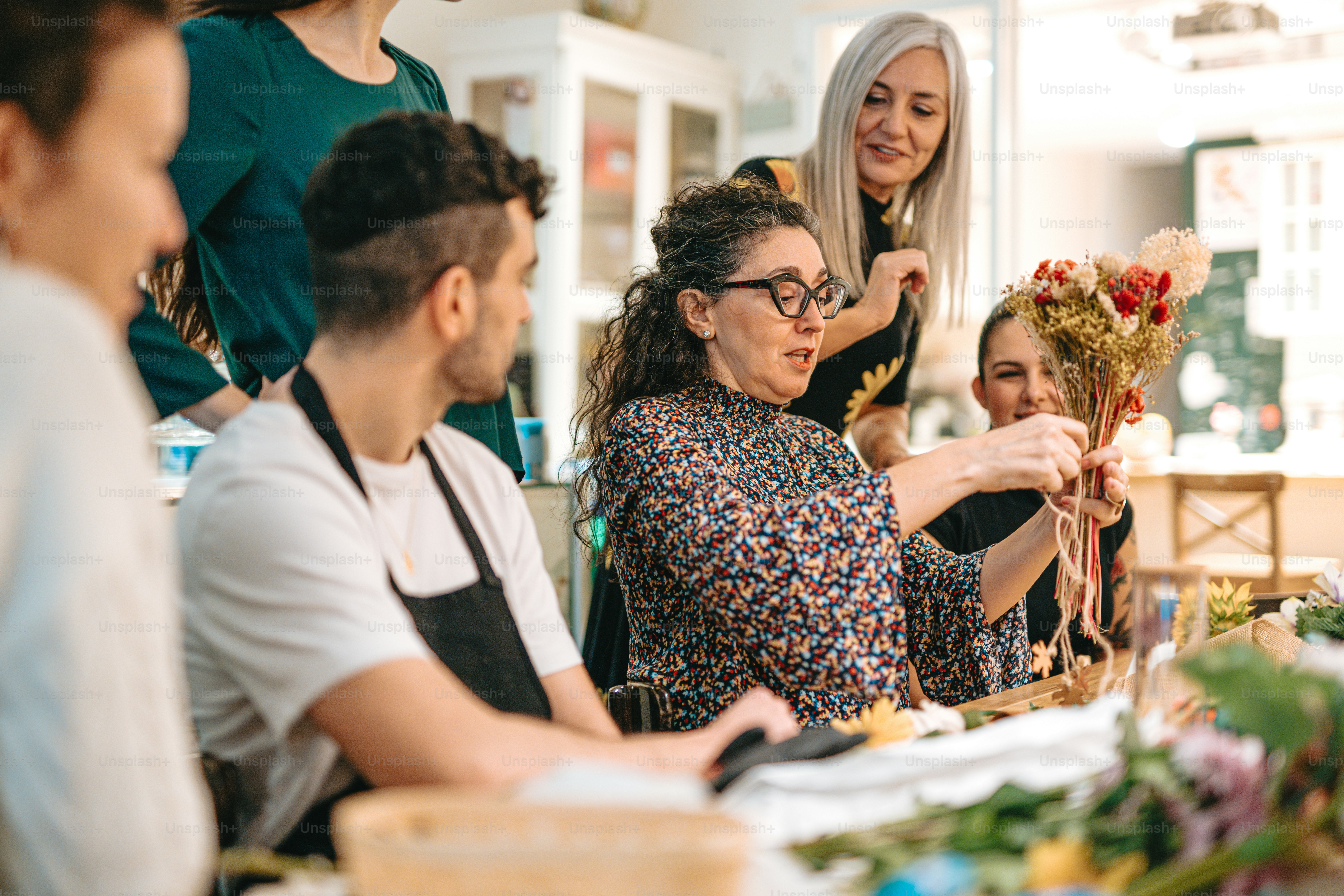 a group of people standing around a table
