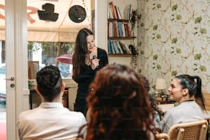 a woman standing in front of a group of people