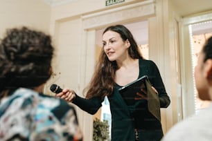 a woman standing in front of a mirror holding a clipboard