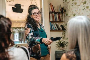 a woman holding a hair dryer in her hands