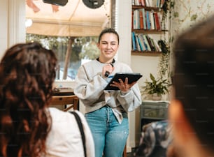 a woman standing in a room holding a tablet